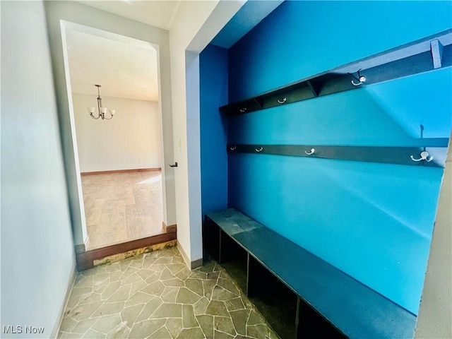 mudroom with a chandelier