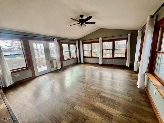 unfurnished sunroom with ceiling fan and vaulted ceiling