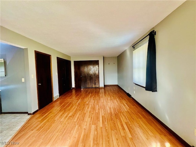 spare room featuring light hardwood / wood-style floors