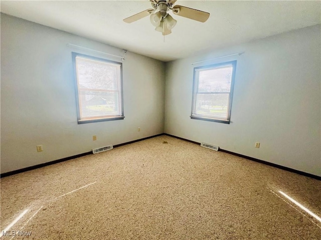 carpeted empty room with ceiling fan