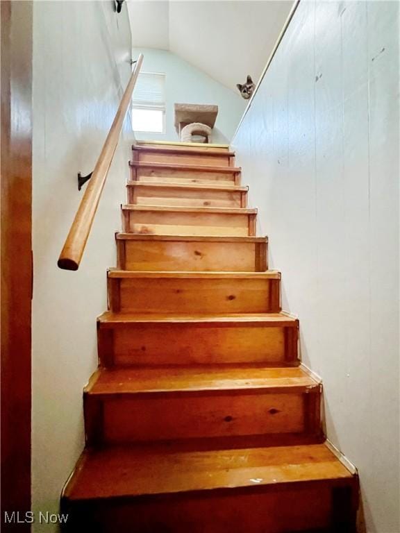 staircase with lofted ceiling