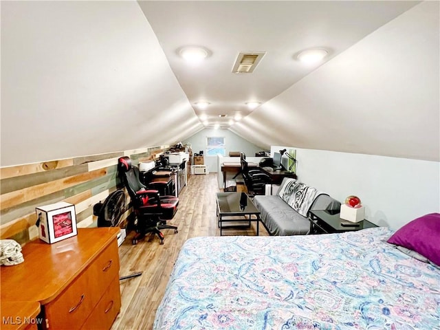 bedroom featuring vaulted ceiling and light hardwood / wood-style floors