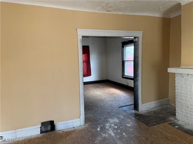 unfurnished room with a textured ceiling