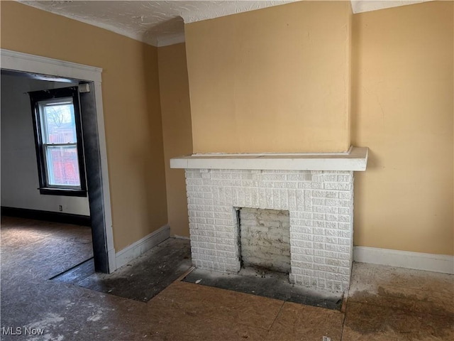 unfurnished living room featuring a brick fireplace