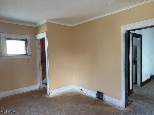 unfurnished room with a textured ceiling