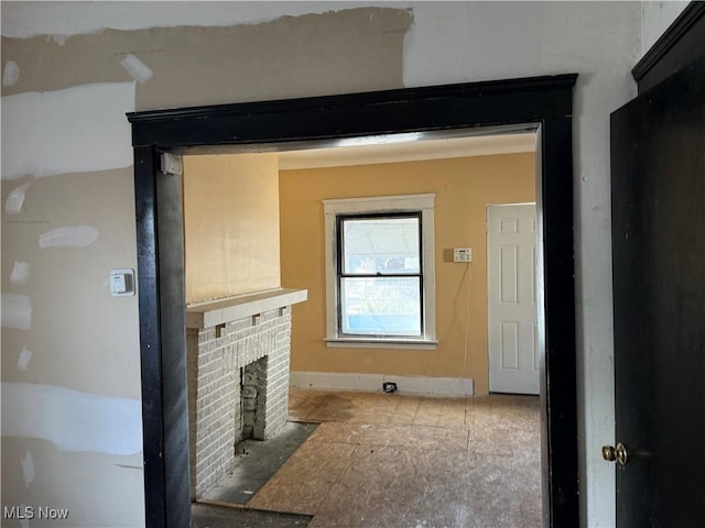 living room with a brick fireplace