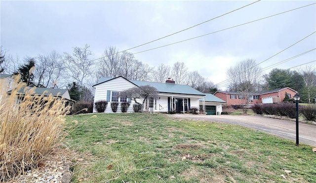 ranch-style home featuring a garage and a front lawn