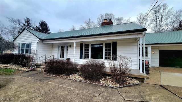 single story home featuring a garage and covered porch