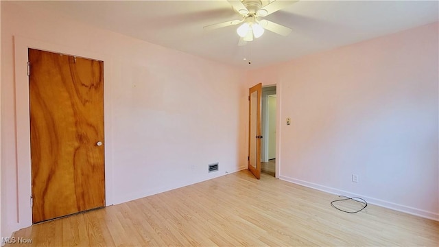 empty room featuring ceiling fan and light hardwood / wood-style flooring