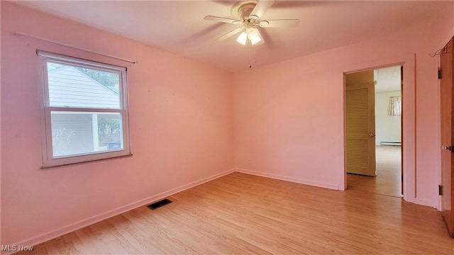 unfurnished room featuring ceiling fan, a baseboard radiator, and light hardwood / wood-style floors