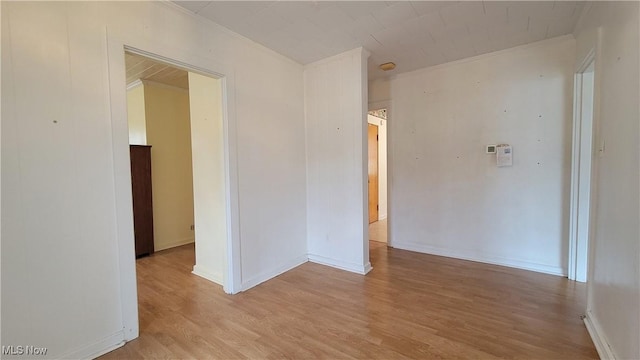 spare room with crown molding and light hardwood / wood-style floors