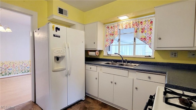 kitchen featuring white cabinetry, sink, white refrigerator with ice dispenser, and gas stove