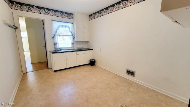 clothes washing area featuring sink