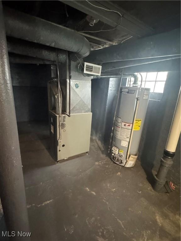 basement featuring heating unit and gas water heater