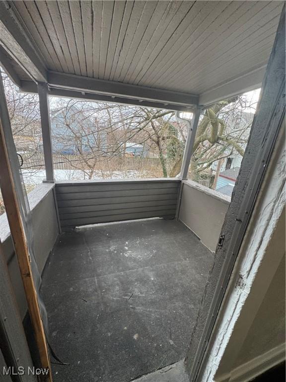 unfurnished sunroom with wood ceiling