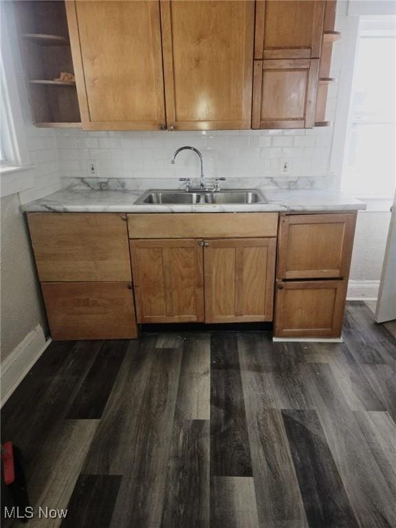 kitchen with sink, dark hardwood / wood-style flooring, and decorative backsplash