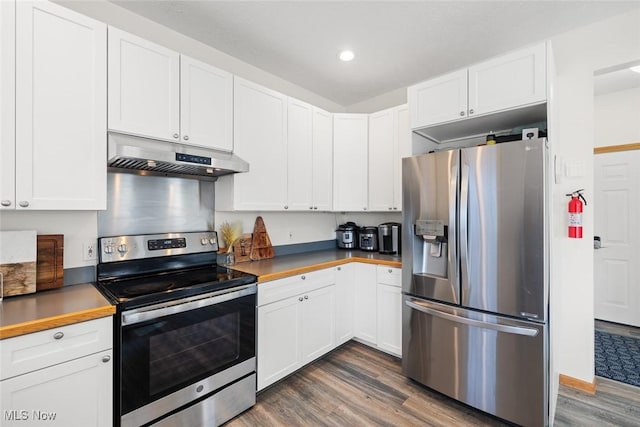 kitchen featuring butcher block counters, dark hardwood / wood-style floors, white cabinets, and appliances with stainless steel finishes