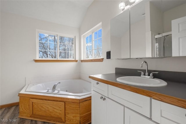 bathroom featuring lofted ceiling, hardwood / wood-style floors, vanity, and independent shower and bath