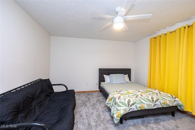 carpeted bedroom with ceiling fan and a textured ceiling