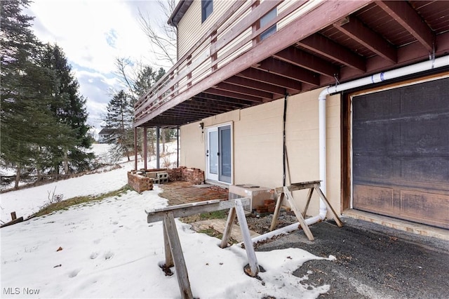 view of snow covered exterior with ac unit