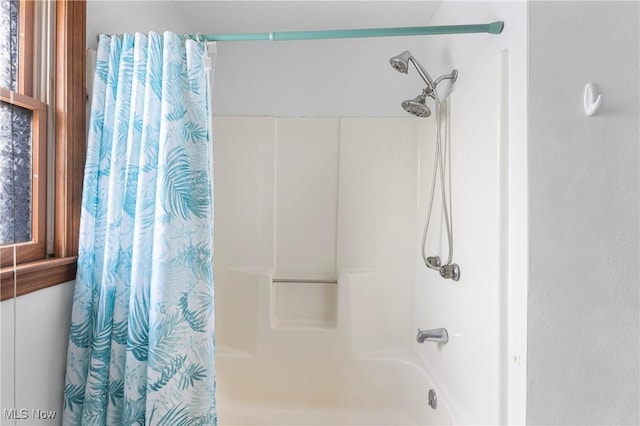 bathroom featuring shower / tub combo with curtain