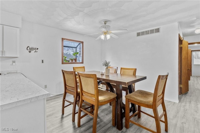 dining space featuring ceiling fan and light hardwood / wood-style flooring