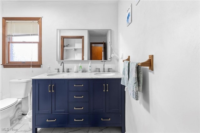 bathroom featuring vanity and toilet