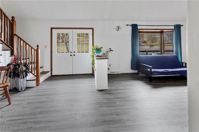 entryway with hardwood / wood-style floors, plenty of natural light, and french doors