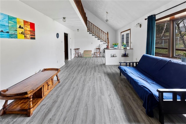 living room with hardwood / wood-style flooring and vaulted ceiling