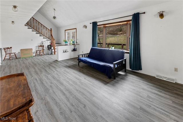 living room with hardwood / wood-style flooring and lofted ceiling