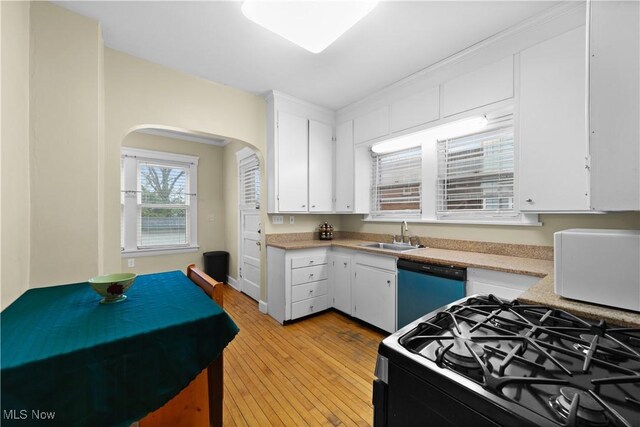 kitchen with sink, white cabinetry, gas range, dishwasher, and light hardwood / wood-style floors