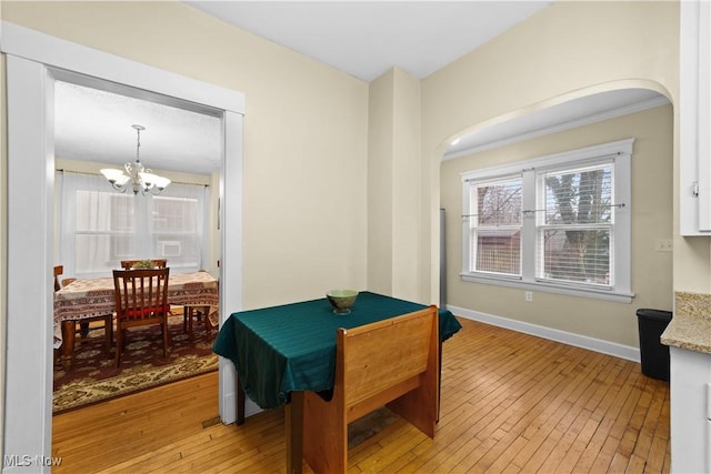 game room with ornamental molding, a chandelier, and light hardwood / wood-style flooring