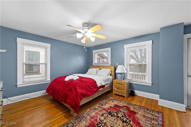 bedroom featuring hardwood / wood-style flooring and ceiling fan