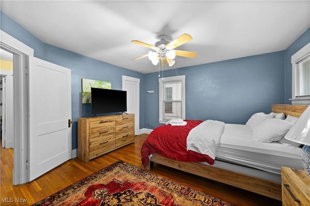 bedroom with dark wood-type flooring and ceiling fan