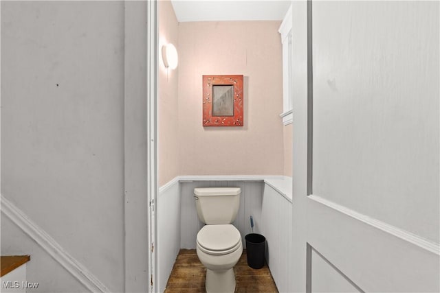 bathroom with hardwood / wood-style flooring and toilet