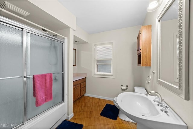 bathroom with vanity and enclosed tub / shower combo