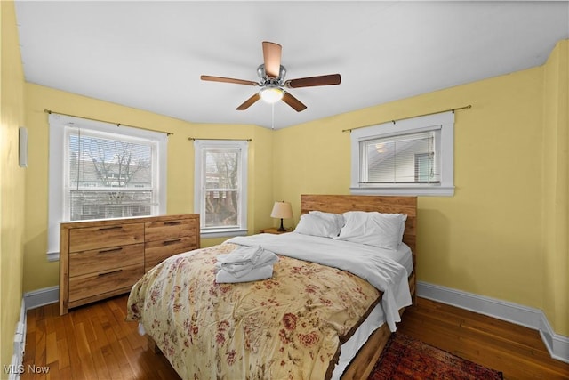 bedroom with dark wood-type flooring and ceiling fan