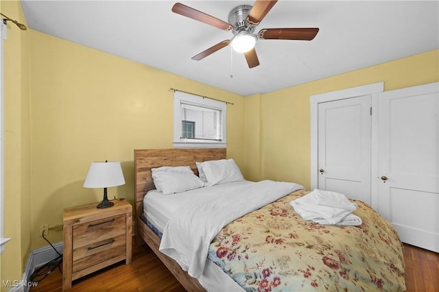 bedroom with ceiling fan and dark hardwood / wood-style floors