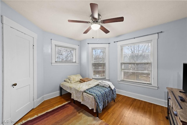 bedroom with hardwood / wood-style flooring and ceiling fan