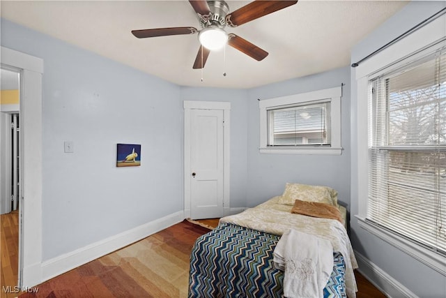 bedroom with hardwood / wood-style flooring and ceiling fan