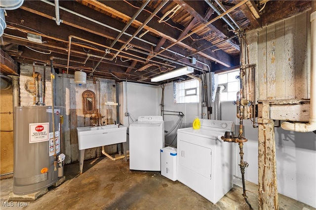 basement with washer and dryer, sink, and water heater