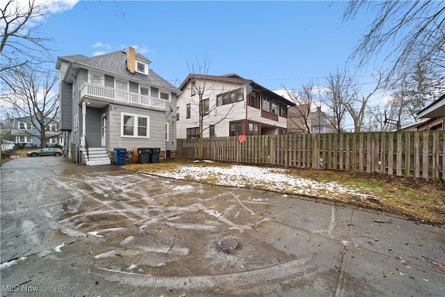 rear view of property with a balcony