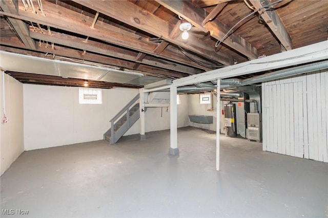 basement featuring sink, heating unit, and gas water heater