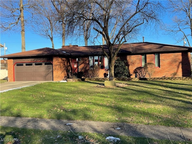 view of front of house featuring a garage and a front lawn