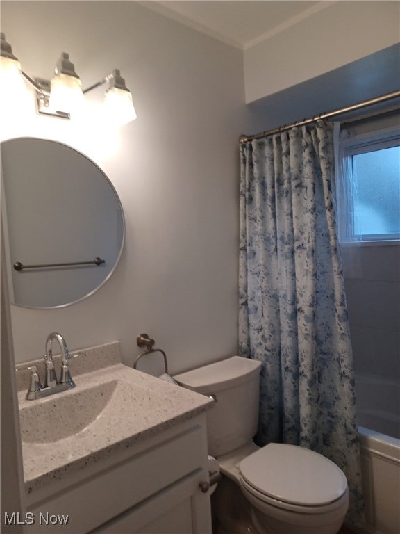 full bathroom with vanity, ornamental molding, toilet, and shower / bath combo with shower curtain