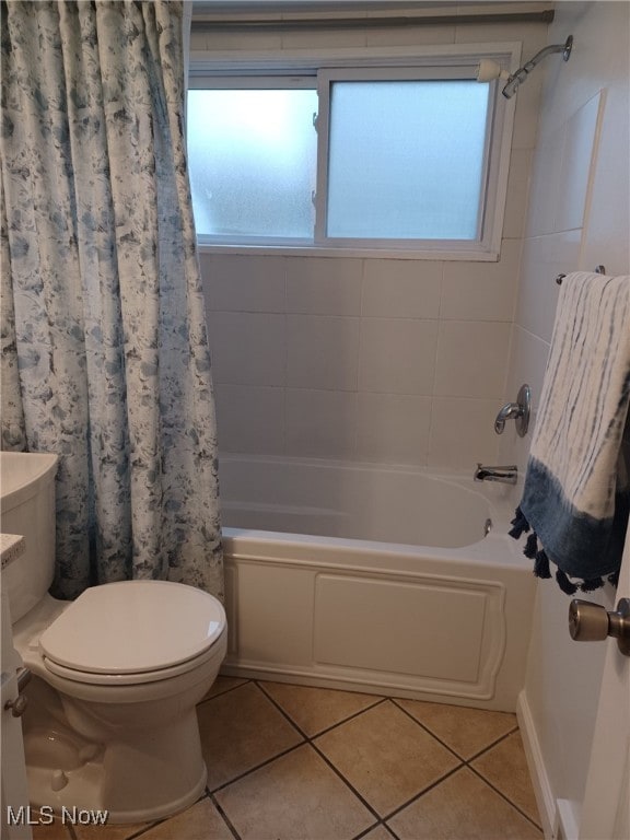 full bathroom with shower / bath combination with curtain, plenty of natural light, toilet, and tile patterned flooring