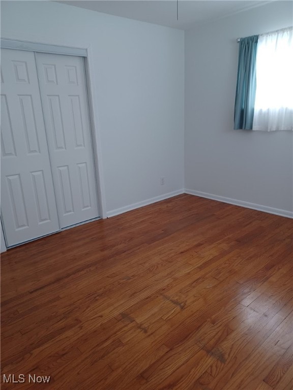 unfurnished room featuring dark hardwood / wood-style floors