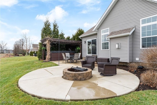 view of patio / terrace with a hot tub and a fire pit