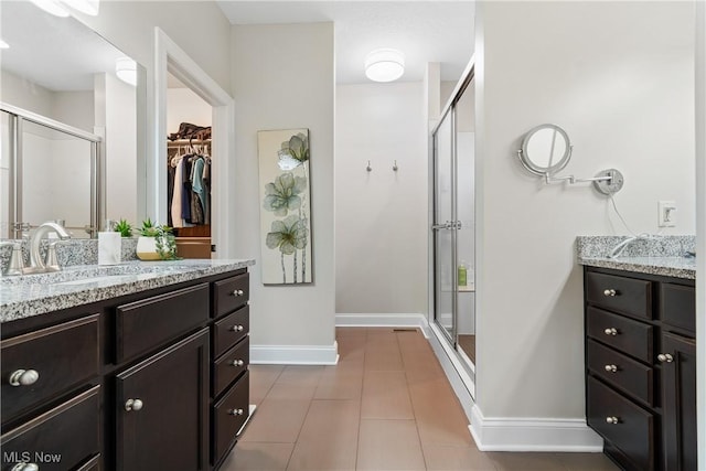 bathroom with vanity, tile patterned floors, and a shower with shower door