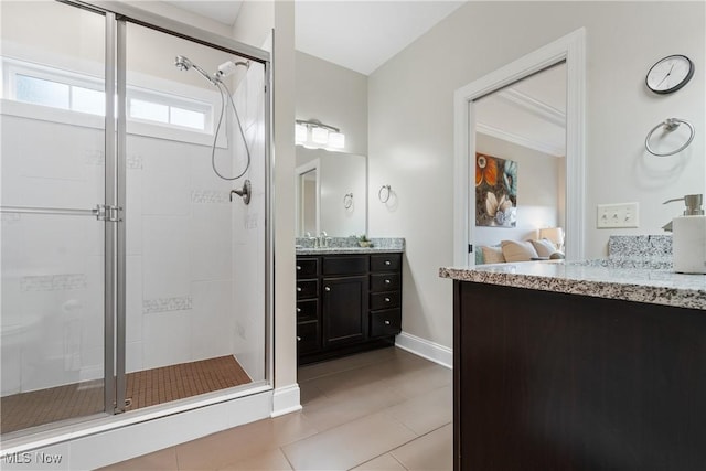 bathroom featuring vanity, tile patterned flooring, and a shower with door